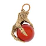 A 1970s 9ct gold carnelian sphere and eagle claw pendant.