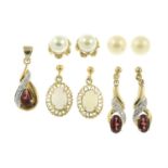 Three pairs of earrings and a garnet and diamond pendant and earring set.