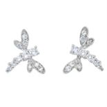 A pair of cubic zirconia dragonfly earrings.