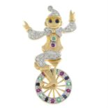 A 9ct gold diamond, ruby, emerald and sapphire articulated pendant of a clown riding a unicycle.