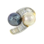 A vari-hue cultured pearl crossover ring, with baguette-cut diamond shoulders.