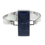 A silver sodalite push bangle, by Ralph Weston.