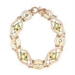 An early 20th century 9ct gold peridot and split pearl bracelet of openwork design. AF.