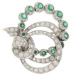 An emerald and vari-cut diamond brooch.