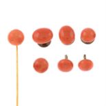 A coral stickpin and three pairs of coral dress studs.