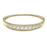 A 9ct gold diamond bangle of Greek key pattern.