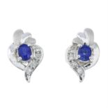 A pair of sapphire and diamond stud earrings.