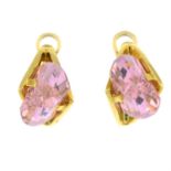 A pair of pink cubic zirconia earrings.