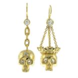 A pair of vari-cut diamond skull drop earrings.