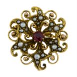 An early 20th century gold garnet and split pearl brooch.