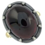 A foil-back garnet cabochon ring.