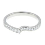 A platinum brilliant-cut diamond shaped half eternity ring.