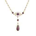 An early 20th century gold garnet pendant, suspended from later integral 9ct gold chain.