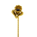 A late Victorian Etruscan revival gold garnet stickpin.