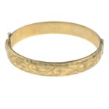 A 9ct gold hinged bangle.