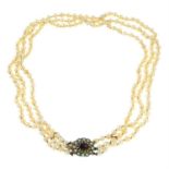 A cultured pearl three-row necklace, with garnet and split pearl cluster clasp.