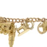 A charm bracelet, suspending thirteen charms, gathered at a 9ct gold heart-shape padlock clasp.