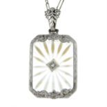 A mid 20th century silver diamond and carved rock crystal pendant, with fancy-link chain.