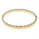 A 9ct tri-colour gold hinged bangle.