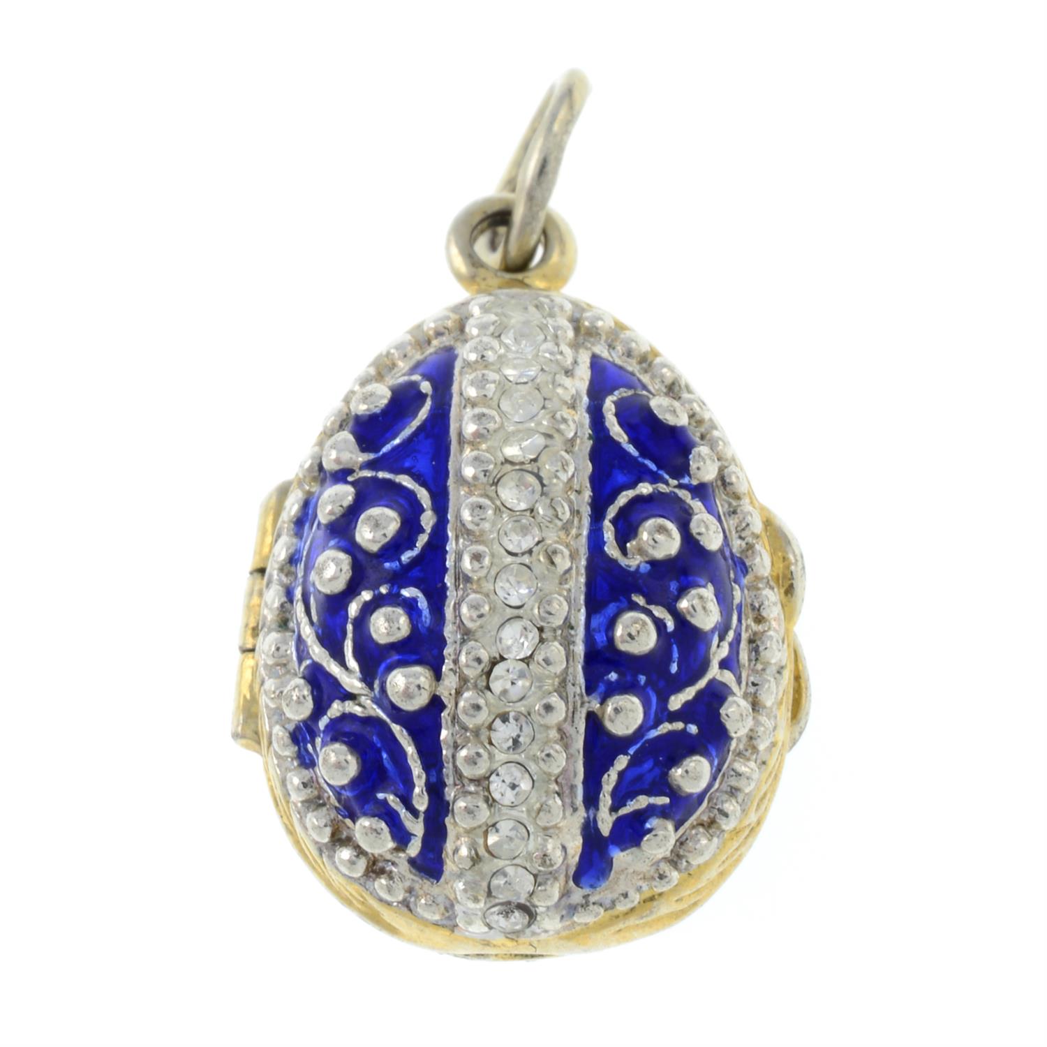 An enamel egg pendant, open to reveal an apple, with colourless paste accents.