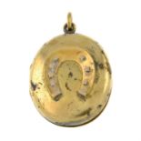 An early 20th century gold locket, with horseshoe motif.