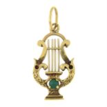 A lyre pendant, with green gem highlight.