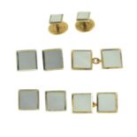 A set of early 20th century 9ct and 18ct gold mother-of-pearl dress studs.