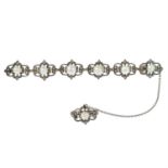 An early 20th century silver and 9ct gold, rose-cut diamond and pearl openwork brooch.