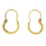 A pair of twisted hoop earrings.