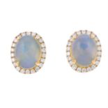A pair of opal cabohcon and brilliant-cut diamond cluster stud earrings.