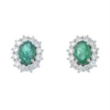 A pair of 18ct gold emerald and brilliant-cut diamond cluster earrings.