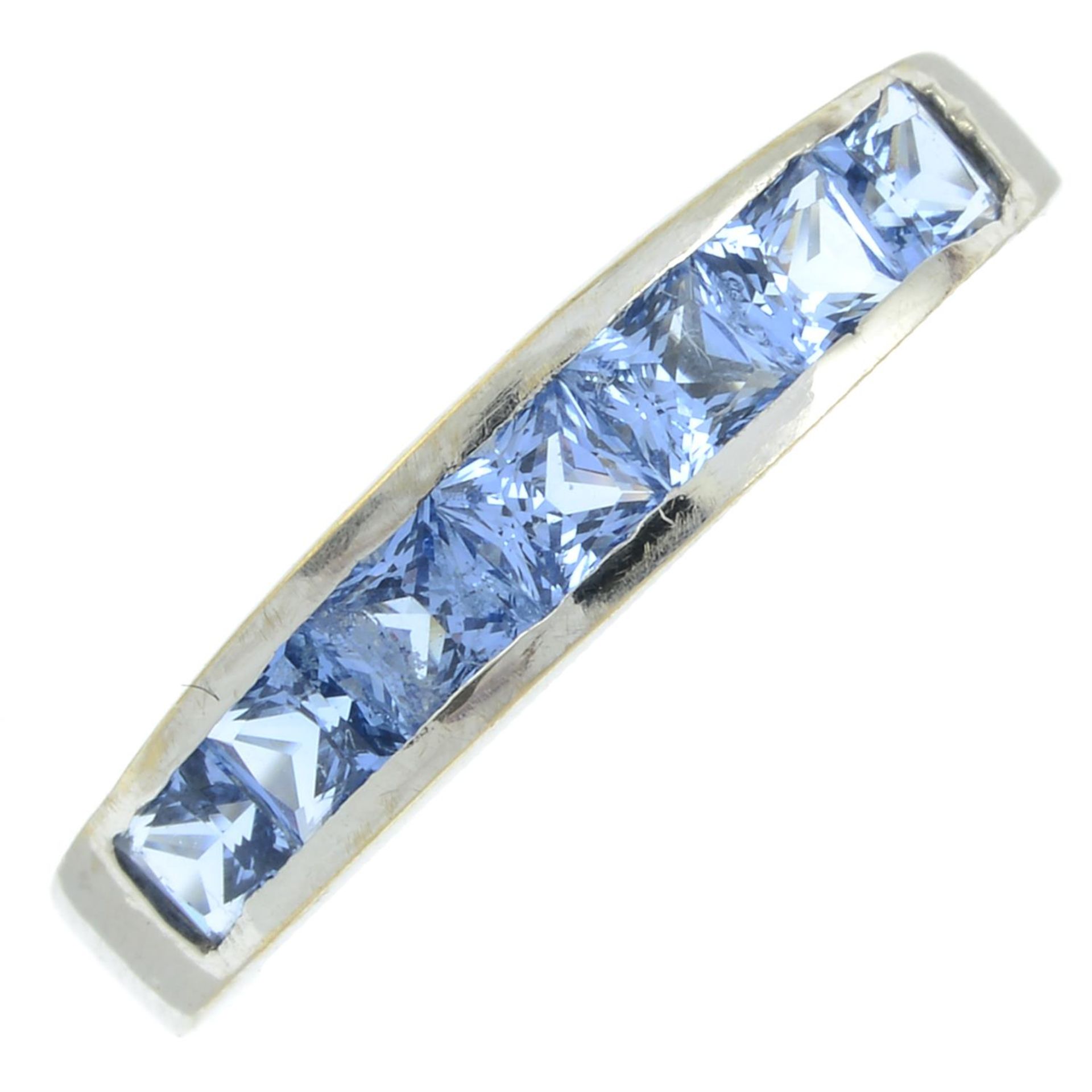 A synthetic blue spinel half eternity ring.