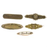 Five late 19th century 9ct gold variously designed brooches.