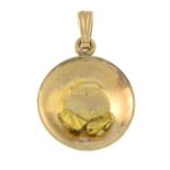 A circular-shape pendant, set with two gold nugget highlights.