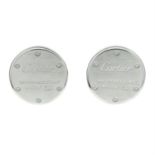 A pair of silver brand logo round cufflinks by, CARTIER.