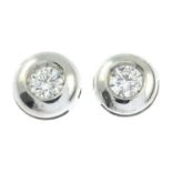 A pair of brilliant-cut diamond collet single-stone earrings.