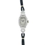 A mid 20th century platinum brilliant-cut diamond cocktail watch, with fabric strap.