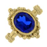 A 9ct gold blue synthetic spinel ring with beaded detail.