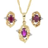 A diamond and ruby pendant necklace and matching earrings.