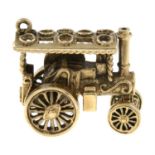 A 9ct gold steam powered car charm.