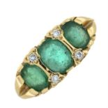 A 9ct gold emerald three-stone ring, with diamond accents.