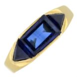 A synthetic sapphire three-stone ring.