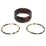 Three tortoise shell bangles.