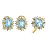 A blue topaz and diamond cluster ring and earring set.