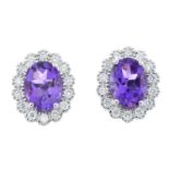 A pair of 18ct gold amethyst and diamond cluster earrings.
