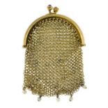 An early 20th century gold mesh coin purse, with synthetic ruby and seed pearl highlights. AF.