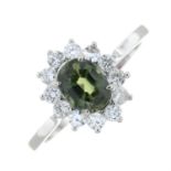 A green sapphire and diamond cluster ring.