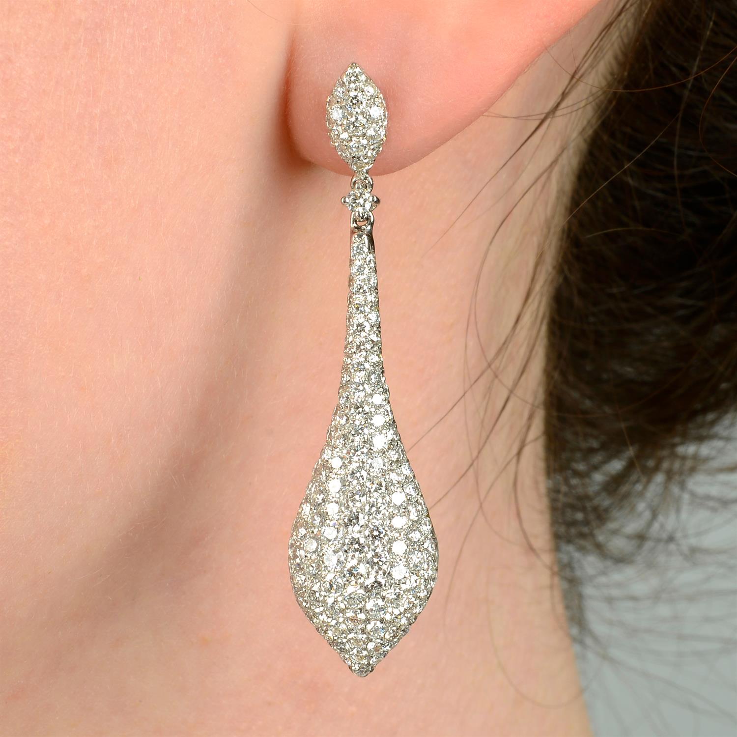 A pair of pavé-set diamond earrings.