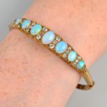 An early 20th century 18ct gold opal and old-cut diamond bangle.