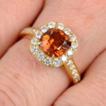 An orange zircon and brilliant-cut diamond cluster ring.